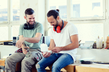 Wall Mural - two worker in a carpenter's workshop taking a break