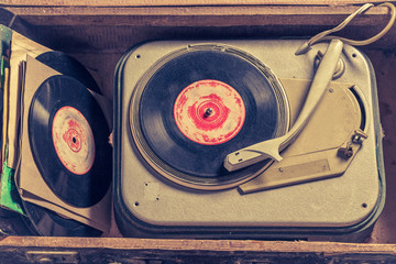 Old gramophone and stack of vinyl in an old suitcase