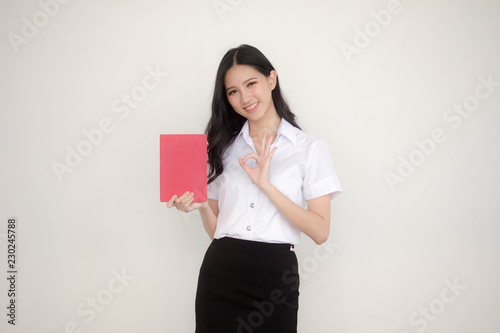 Fotografía Portrait of thai adult student university uniform beautiful girl read red book