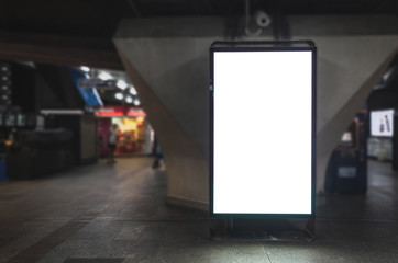 Wall Mural - big blank billboard white led screen vertical outstanding in the city on pathway walking at sky trai