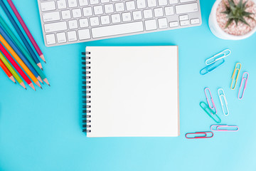 Blank notebook with keyboard and pencil on blue background,Flat lay photo of notebook for your message