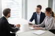 © fizkes - Two hr managers talking with candidate for vacancy. Job seeker at job interview answering questions of employer. Hiring, staff recruiting process.