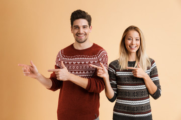 Poster - Portrait of a happy young couple dressed in sweaters