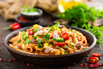 Canvas Print - Spicy pasta penne bolognese with vegetables, beans, chili and cheese in tomato sauce