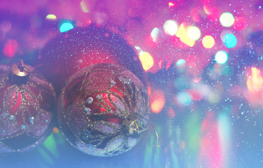 Wall Mural - christmas ball close-up on the background of lanterns blurred by a purple and blue background and ru