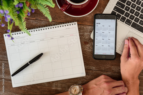Fotografía SEPTEMBER 17, 2018: Working table top with organizer for monthly planing with a