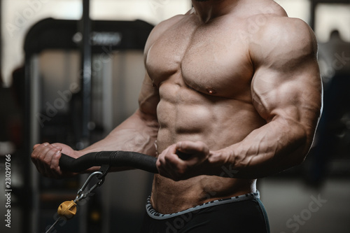Fotografía Brutal strong bodybuilder athletic men pumping up muscles with dumbbells
