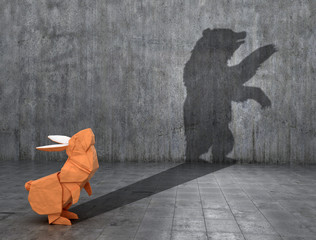 Concept of hidden potential. Paper figure of a rabbit that throws a bear's shadow. 3D illustration