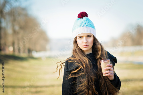 Beautiful Teenage Girl With Long Hair Holding Takeaway Coffee Wearing Winter Outfit And Knitted Hat Natural Lighting Mild Retouch Buy This Stock Photo And Explore Similar Images At Adobe Stock