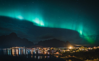 northern lights aurora borealis with classic view of the fisherman s village of reine near hamnoy in