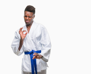 Canvas Print - Young african american man over isolated background wearing kimono disgusted expression, displeased and fearful doing disgust face because aversion reaction. With hands raised. Annoying concept.