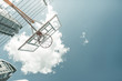 Basketball game. Low angle of a basketball basket handing against a blue sky