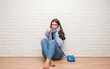 © Krakenimages.com - Young brunette woman sitting on the floor calling on vintage telephone pointing with finger to the camera and to you, hand sign, positive and confident gesture from the front