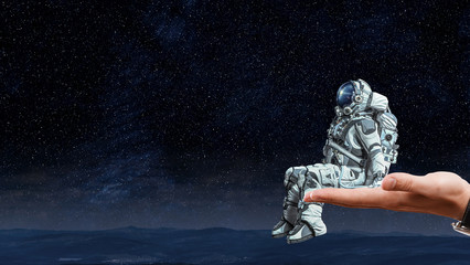 Wall Mural - spaceman on finger. mixed media