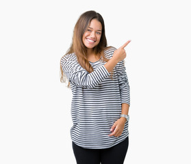 Young beautiful brunette woman wearing stripes sweater over isolated background cheerful with a smile of face pointing with hand and finger up to the side with happy and natural expression on face