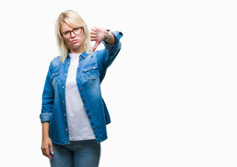 Canvas Print - Young beautiful blonde woman wearing glasses over isolated background looking unhappy and angry showing rejection and negative with thumbs down gesture. Bad expression.