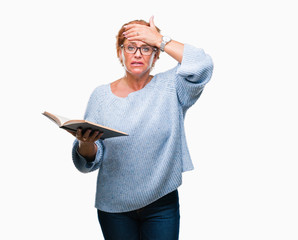 Senior caucasian woman reading a book over isolated background stressed with hand on head, shocked with shame and surprise face, angry and frustrated. Fear and upset for mistake.