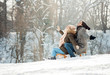 © Tijana - Two young people sliding on a sled