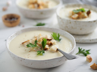 Wall Mural - cauliflower potato soup puree on white marble tabletop, Creamy cauliflower soup with toasted bread croutons. Vegetarian healthy food concept. Ideas and recipes for winter meal. Copy space