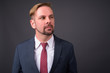 © Ranta Images - Blond bearded businessman with goatee against gray background