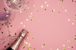 champagne coupes and bottle and confetti, flat lay, copy space