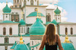 Girl looking at the ancient cathedral of the russian New Jerusalem monastery at sunset