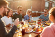 © Syda Productions - leisure and people concept - happy friends having dinner or barbecue party and eating on rooftop in summer