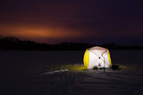 Fototapeta  - Beautiful Landscape Of Winter Fishing At Night. Yellow Fishing Tent On Ice Under Colorful Sky At Night Winter.