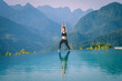 © 220 Selfmade studio - Beautiful Attractive Asian woman practice yoga Warrior I or Virabhadrasana Pose on the pool above the Mountain peak in the morning in front of beautiful nature views in SAPA vietnam