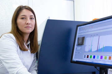 Female Scientist Looking On Computer Screen In Lab