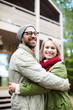 © pressmaster - Portrait of young beautiful stylish Caucasian couple embracing each other and smiling happily while standing outdoors on blurred background
