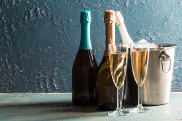 Wall Mural - Champagne bottle in bucket with ice and glasses of champagne