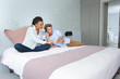 © auremar - couple in hotel room calling room service