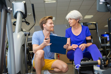 senior woman working out with personal trainer