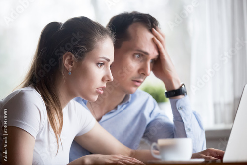 Cuadros en Lienzo Head shot young millennial anxious spouses looking at computer screen