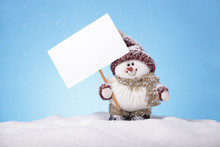 Snowman On Snow Holding A Blank Card