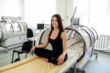 Beautiful Girl In A Black T-shirt And White Pants Lies In A Hyperbaric Chamber
