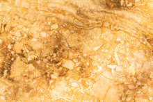 Stone Gold Wall Marble Texture For Background. Natural Marble Stone Texture In Warm Colors. Background With Small Waves And A Round Pattern. Brown, Orange, Gold, Yellow And Beige Shades.