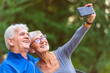 © lordn - Smiling senior couple in the park taking selfie