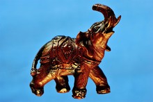 Elephant Figure On A Bright Blue Background-a Family Of Mammals Of The Proboscis. Elephants Are The Largest Land Animals On Earth. They Live In Southeast Asia And Africa In Tropical Forests And Savann