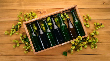 Canvas Print - A set of beer in a wooden box. On a wooden background. Free space for text. Top view.