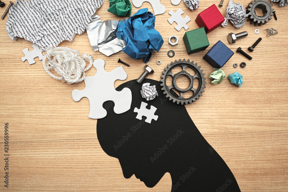 Concept image of mental exhaustion and brain fatigue. Concentration problems. various parts and head silhouette on wood background. - obrazy, fototapety, plakaty 