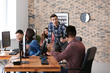 Wall Mural - Young people playing video games at tournament