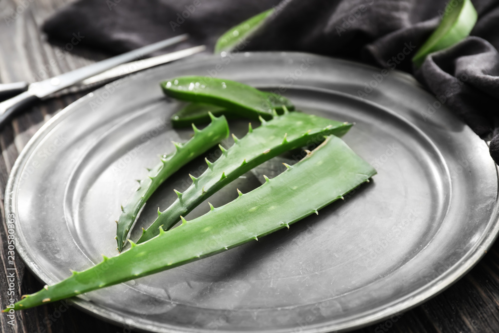 Fresh aloe vera leaves on metal tray
