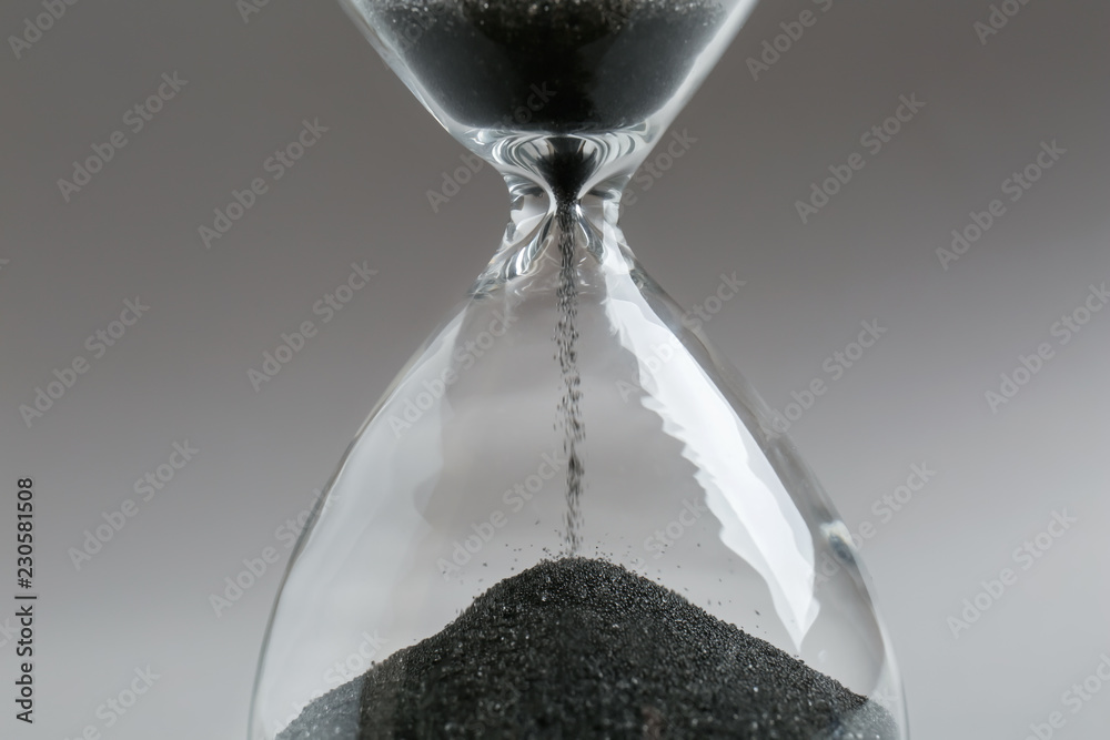 Crystal hourglass on light background, closeup