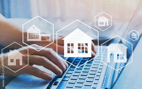 Fotografía buy house, real estate concept, different offers of property online, hands typin