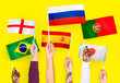 © Rawpixel.com - Hands raising national flags of England, Spain, Japan, Portugal, Russia, and Brazil