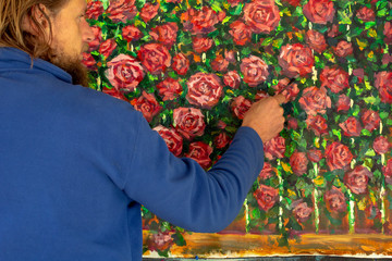 Sticker - Painter man paints flowers of roses oil painting on canvas