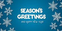 Season's Greetings And Happy New Year Greeting Card Concept With White Snowflakes And Blue Background