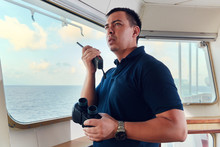 Portrait Of Navigator / Pilot / Officer On The Bridge Of The Vessel